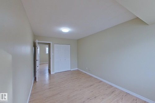 Unfurnished bedroom with light wood-style flooring and a closet - 112 Dickinsfield Court Nw, Edmonton, AB - Indoor Photo Showing Other Room