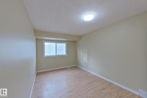 Spare room featuring light wood finished floors and baseboards - 112 Dickinsfield Court Nw, Edmonton, AB - Indoor Photo Showing Other Room