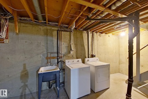 Washroom featuring concrete floors and washing machine and dryer - 112 Dickinsfield Court Nw, Edmonton, AB - Indoor Photo Showing Laundry Room