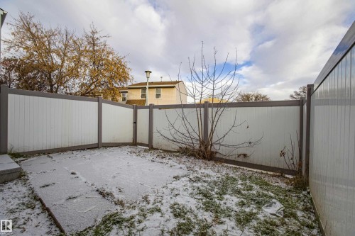 Yard covered in snow featuring a fenced backyard - 112 Dickinsfield Court Nw, Edmonton, AB - Outdoor