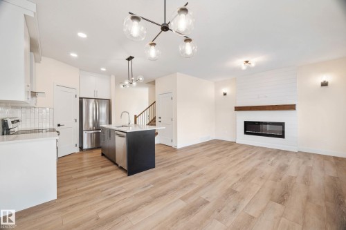 374 Bluff Cove, Leduc, AB - Indoor Photo Showing Kitchen With Fireplace With Upgraded Kitchen