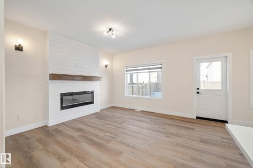 374 Bluff Cove, Leduc, AB - Indoor Photo Showing Living Room With Fireplace