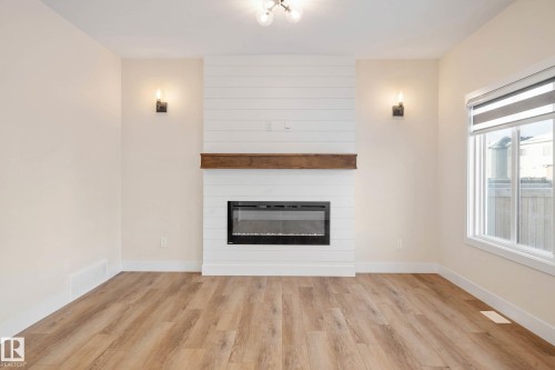 374 Bluff Cove, Leduc, AB - Indoor Photo Showing Living Room With Fireplace