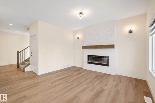 374 Bluff Cove, Leduc, AB - Indoor Photo Showing Living Room With Fireplace