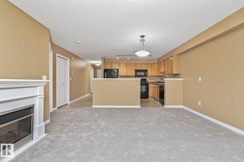 110 1589 Glastonbury Boulevard, Edmonton, AB - Indoor With Fireplace