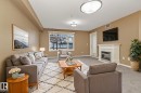 110 1589 Glastonbury Boulevard, Edmonton, AB  - Indoor Photo Showing Living Room With Fireplace 