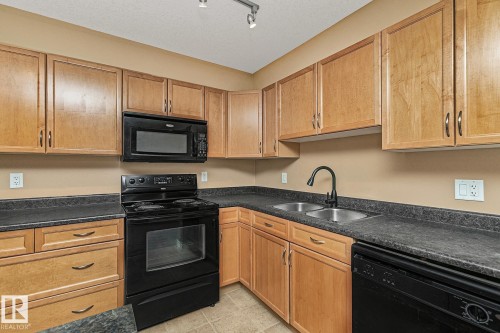 110 1589 Glastonbury Boulevard, Edmonton, AB - Indoor Photo Showing Kitchen With Double Sink