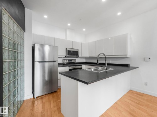 105 11415 100 Avenue, Edmonton, AB - Indoor Photo Showing Kitchen With Stainless Steel Kitchen With Double Sink