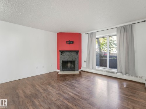 107 10421 93 Street, Edmonton, AB - Indoor Photo Showing Living Room With Fireplace