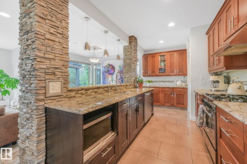 2441 Bowen Wynd, Edmonton, AB - Indoor Photo Showing Kitchen With Fireplace