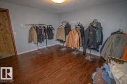 Walk in closet with baseboard heating and wood finished floors - 