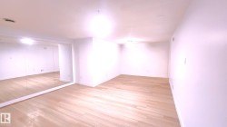 Spare room featuring light wood finished floors and baseboards - 