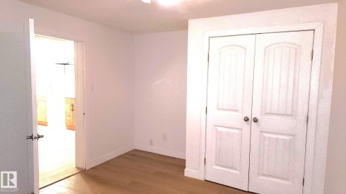 Unfurnished bedroom with wood finished floors and a closet - 11516 133A Avenue, Edmonton, AB - Indoor Photo Showing Other Room
