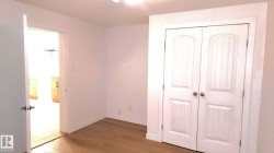 Unfurnished bedroom with wood finished floors and a closet - 