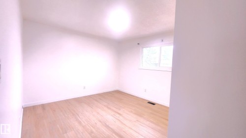 Unfurnished room with light wood-type flooring and baseboards - 11516 133A Avenue, Edmonton, AB - Indoor Photo Showing Other Room