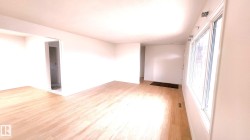 Spare room featuring light wood-style floors and baseboards - 