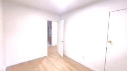 Unfurnished bedroom with light wood-type flooring and baseboards - 