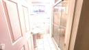 Bathroom with tile walls, a stall shower, and light tile patterned floors - 11516 133A Avenue, Edmonton, AB  - Indoor Photo Showing Bathroom 