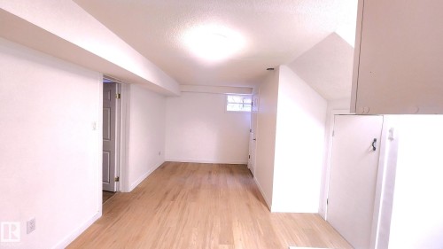 Bonus room featuring a textured ceiling and light wood-style flooring - 11516 133A Avenue, Edmonton, AB - Indoor Photo Showing Other Room
