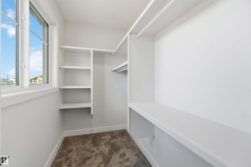 Walk in closet featuring dark colored carpet - 94 Eldridge Pointe, St. Albert, AB - Indoor With Storage