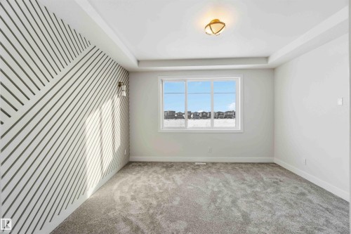 Spare room featuring light colored carpet and a raised ceiling - 94 Eldridge Pointe, St. Albert, AB - Indoor Photo Showing Other Room