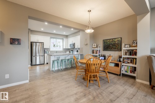 Dining area with light wood finished floors and recessed lighting - 5 2072 Wonnacott Way, Edmonton, AB - Indoor Photo Showing Other Room