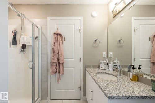 Full bathroom featuring vanity, a shower stall, light tile patterned flooring, and a textured ceiling - 5 2072 Wonnacott Way, Edmonton, AB - Indoor Photo Showing Bathroom