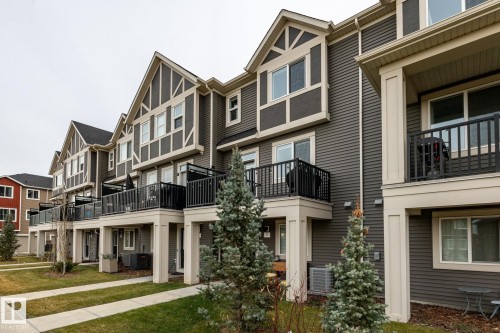 View of building exterior featuring a residential view - 5 2072 Wonnacott Way, Edmonton, AB - Outdoor With Facade