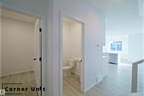 Corridor with light wood-style floors and baseboards - 7585 174A Avenue, Edmonton, AB - Indoor