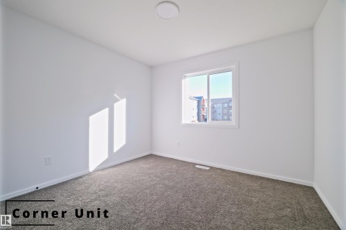 Carpeted spare room with baseboards - 7585 174A Avenue, Edmonton, AB - Indoor Photo Showing Other Room