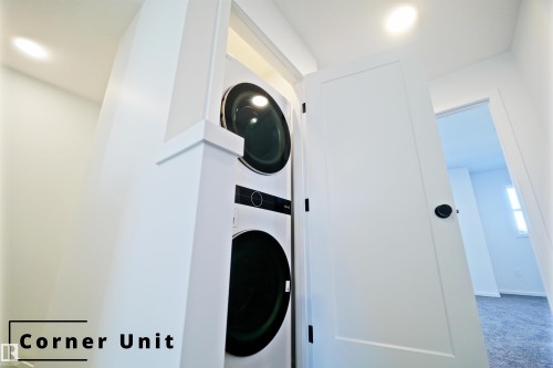 Laundry area with recessed lighting, stacked washing machine and dryer, and carpet flooring - 7585 174A Avenue, Edmonton, AB - Indoor Photo Showing Laundry Room