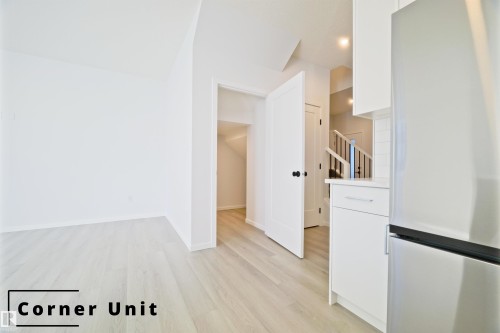 Unfurnished room featuring light wood-type flooring and baseboards - 7585 174A Avenue, Edmonton, AB - Indoor Photo Showing Other Room