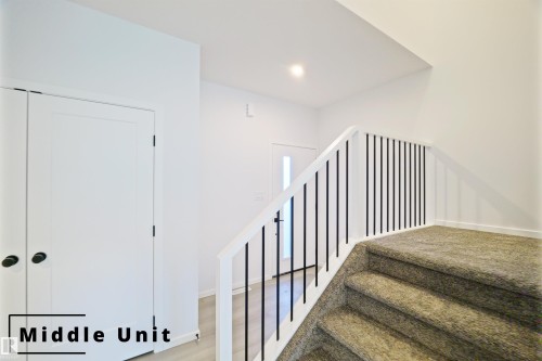 Stairs featuring recessed lighting and wood finished floors - 7585 174A Avenue, Edmonton, AB - Indoor Photo Showing Other Room