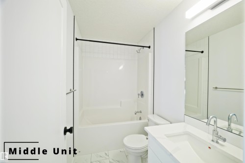 Bathroom with vanity, washtub / shower combination, and marble finish floors - 7585 174A Avenue, Edmonton, AB - Indoor Photo Showing Bathroom