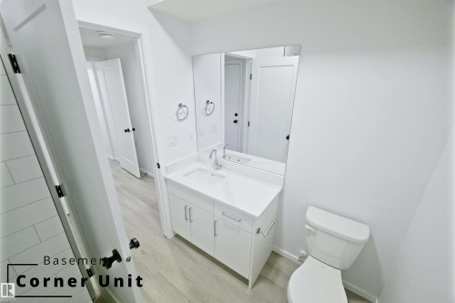 Half bathroom featuring vanity and light wood finished floors - 7585 174A Avenue, Edmonton, AB - Indoor Photo Showing Bathroom