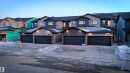 View of front of home with driveway, a shingled roof, and stone siding - 7585 174A Avenue, Edmonton, AB  - Outdoor With Facade 