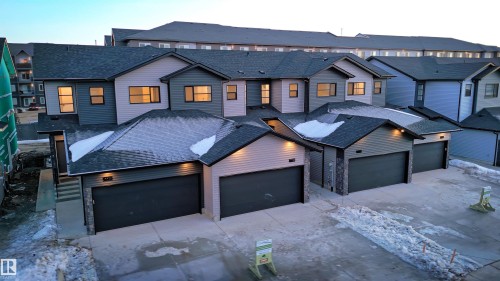 View of front facade featuring a shingled roof, a residential view, and driveway - 7585 174A Avenue, Edmonton, AB - Outdoor