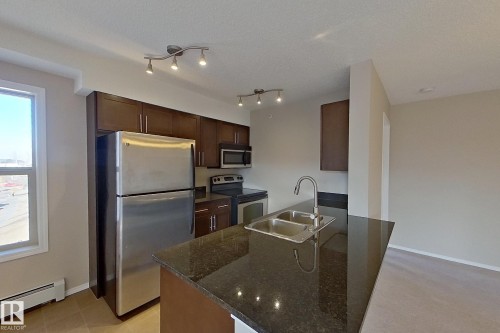 414 11820 22 Avenue, Edmonton, AB - Indoor Photo Showing Kitchen With Stainless Steel Kitchen With Double Sink