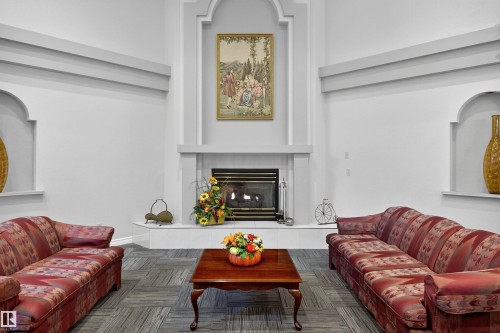 103 10935 21 Avenue, Edmonton, AB - Indoor Photo Showing Living Room With Fireplace