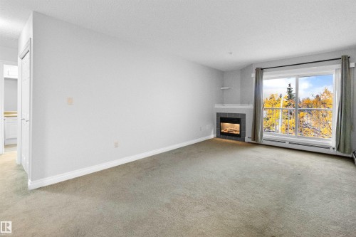 304 11446 40 Avenue, Edmonton, AB - Indoor Photo Showing Living Room With Fireplace