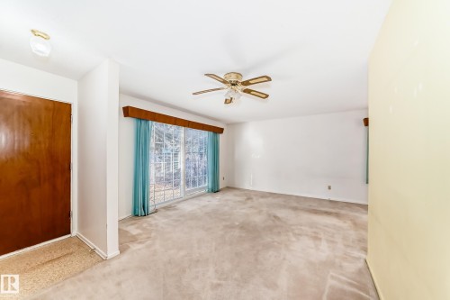 Unfurnished room with carpet floors and a ceiling fan - Edmonton, AB - Indoor Photo Showing Other Room
