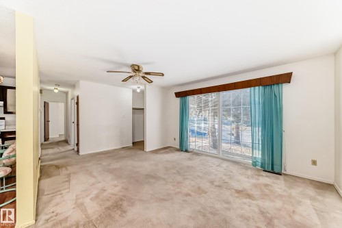 Unfurnished room featuring light colored carpet and ceiling fan - Edmonton, AB - Indoor Photo Showing Other Room
