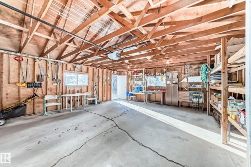 Garage featuring a workshop area and a garage door opener - Edmonton, AB - Indoor