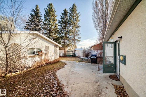 View of property exterior with stucco siding and a patio area - Edmonton, AB - Outdoor