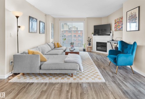 605 9741 110 Street Nw, Edmonton, AB - Indoor Photo Showing Living Room With Fireplace