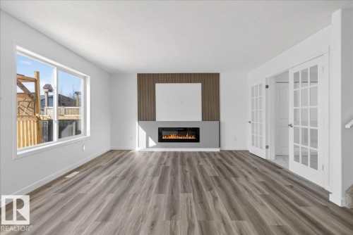 3323 26 Avenue, Edmonton, AB - Indoor Photo Showing Living Room With Fireplace