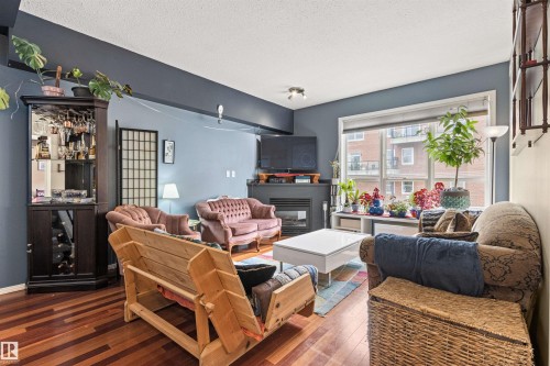 417 10717 83 Avenue, Edmonton, AB - Indoor Photo Showing Living Room With Fireplace