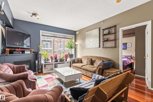 417 10717 83 Avenue, Edmonton, AB - Indoor Photo Showing Living Room With Fireplace