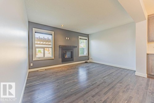 114 Radcliffe Wynd, Fort Saskatchewan, AB - Indoor Photo Showing Living Room With Fireplace