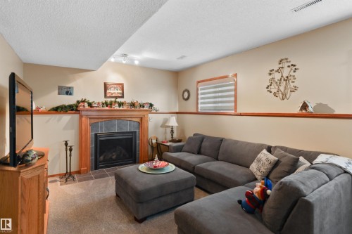 26 Elbow Drive, Devon, AB - Indoor Photo Showing Living Room With Fireplace